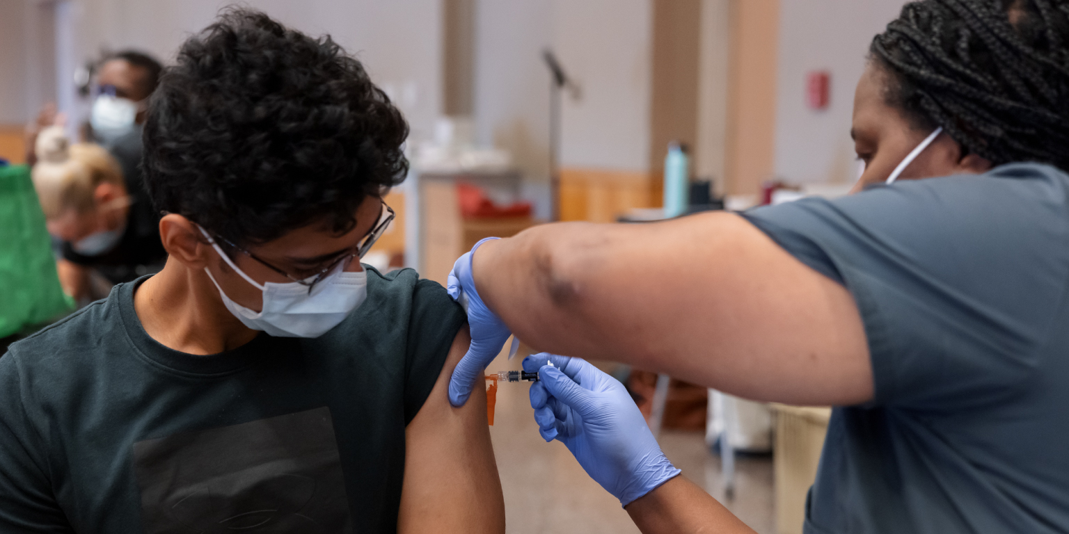 A student receiving an vaccination on campus.